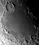 Lunar surface with craters and shadows.