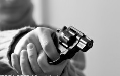 Person holding a small revolver firearm.
