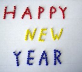 Happy New Year text in colorful pins.