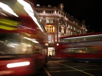 Blurred double-decker buses at night city.