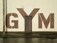 Wall with 'GYM' text and door.