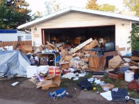 Cluttered garage filled with assorted items.