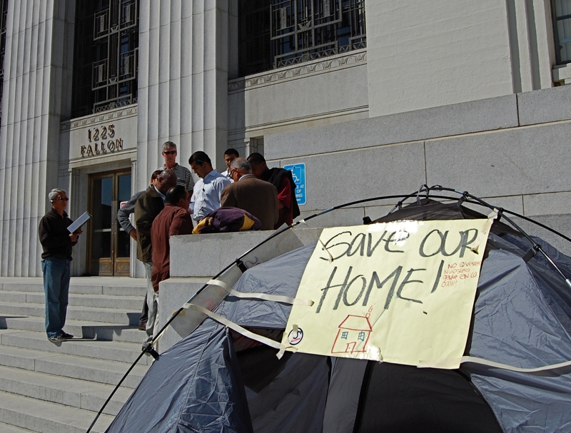 Protesters with tent sign "Save Our Home.