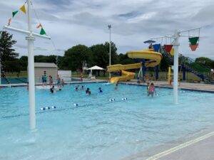 outdoor community pool with kids playing